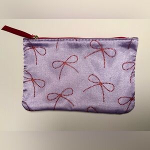 Brand new Ipsy satin cosmetics bag with red sparkle bows, red lining
